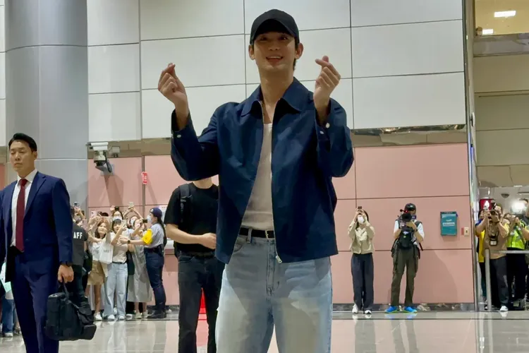 金秀賢走進桃園機場入境大廳，雙手向粉絲比愛心。特勤中心攝