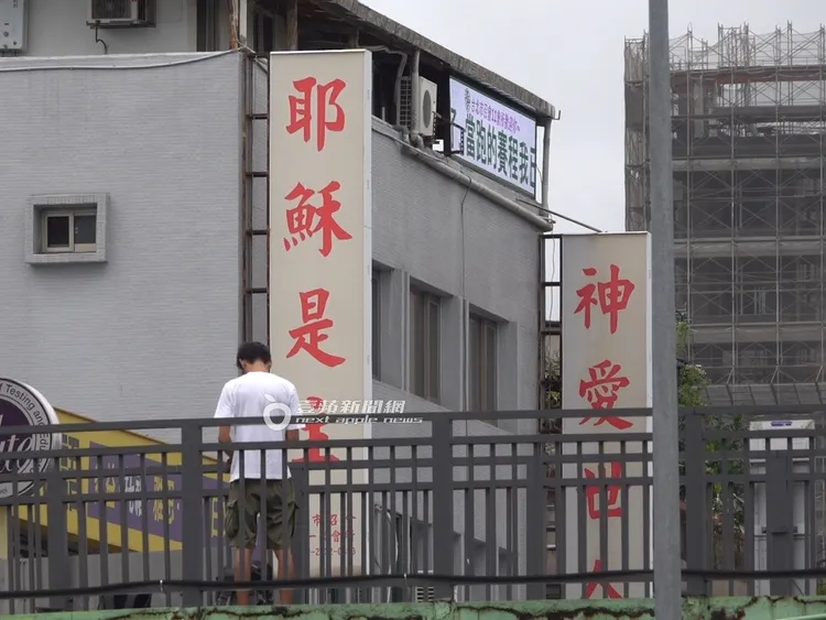 換好衣服的唐治平在天橋上不停對著招牌點頭。攝影中心攝