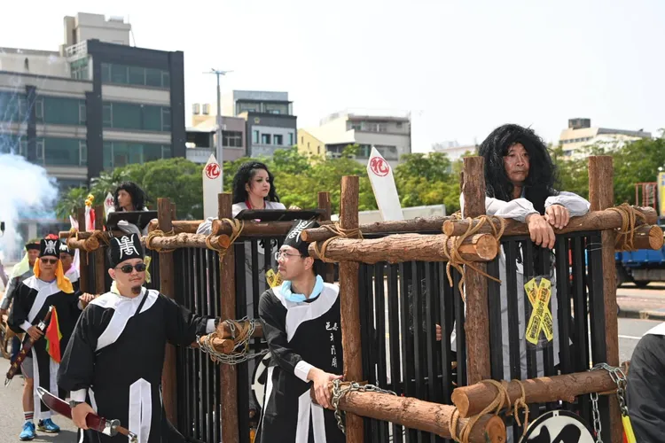 信眾戴著「夯枷」遊行，復刻百年前清朝捕快押解人犯場景，相當特別。嘉義市政府提供