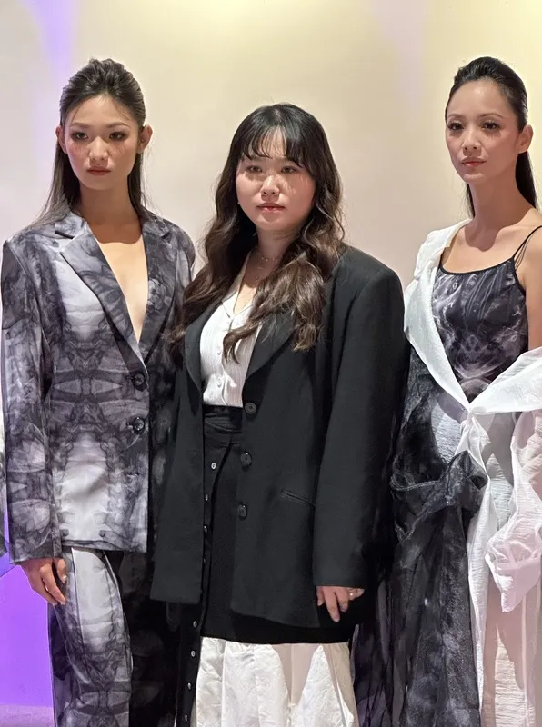 服裝設計師陳凱婷（中）與身著新款服裝的模特兒合影。中央社