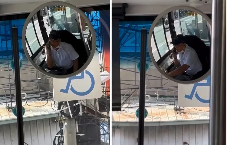 公車駕駛手持手機通話，講到渾然忘我。民眾提供