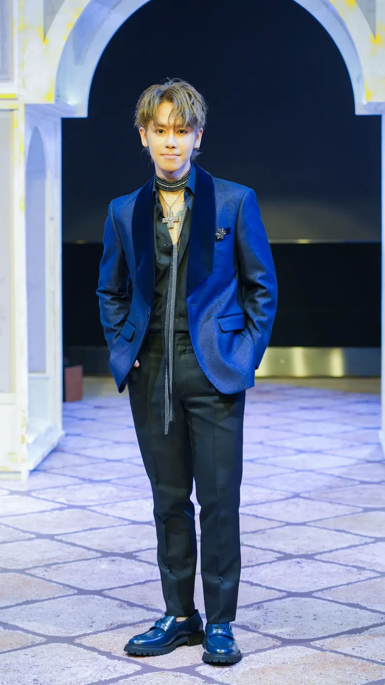 鼓鼓改換上質感深藍色西裝、低胸開襟襯衫。《美麗佳人》提供