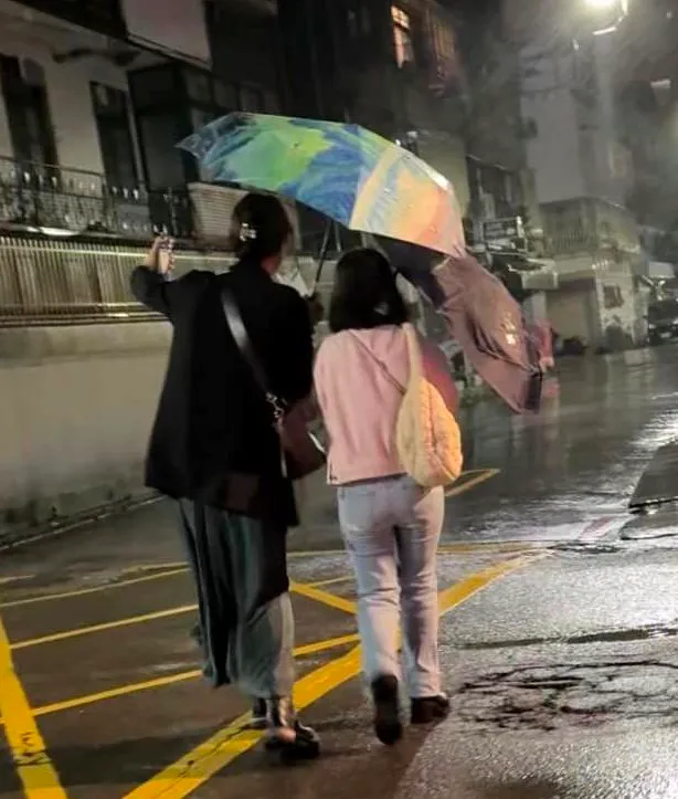 楊月娥與女兒在颱風天撐傘回家，不慎摔倒，翻攝楊月娥臉書