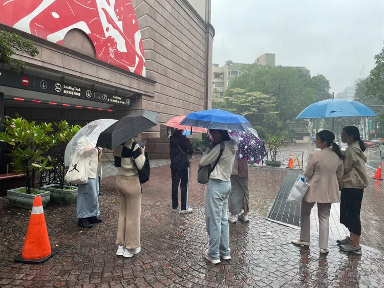 粉絲聚集華仔下榻飯店冒雨駐守。王郁惠攝