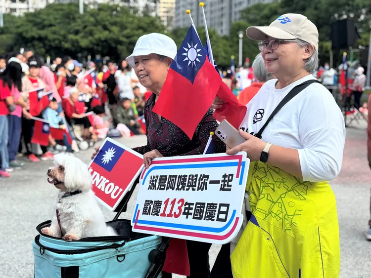 升旗典禮現場超過數千名民眾熱情參與，各式國旗裝扮、舉牌來歡慶這重要的一天。公所提供