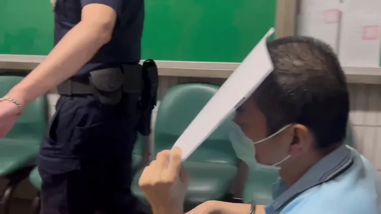 林明佐今出庭時以A4紙遮住面孔，不願讓人看到他現在狼狽模樣。鮮明攝