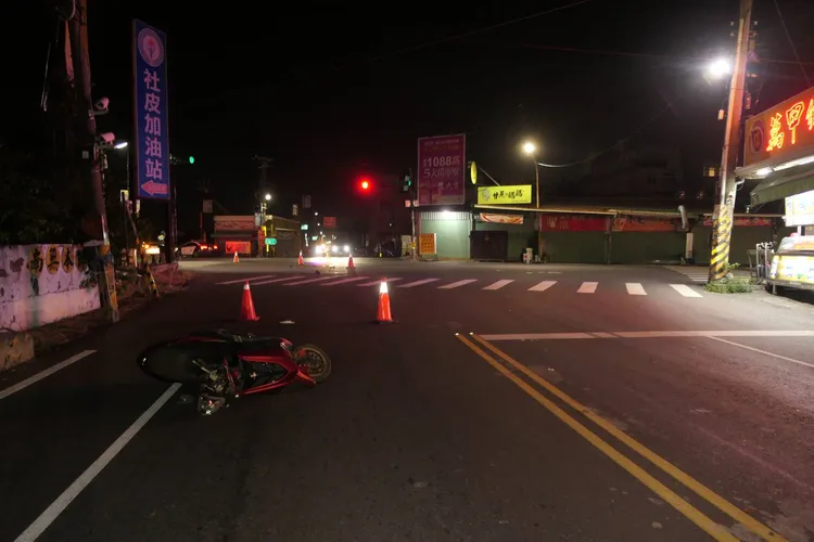 機車騎士遭撞擊後重摔路口，紅色機車往前噴飛才倒下。民眾提供