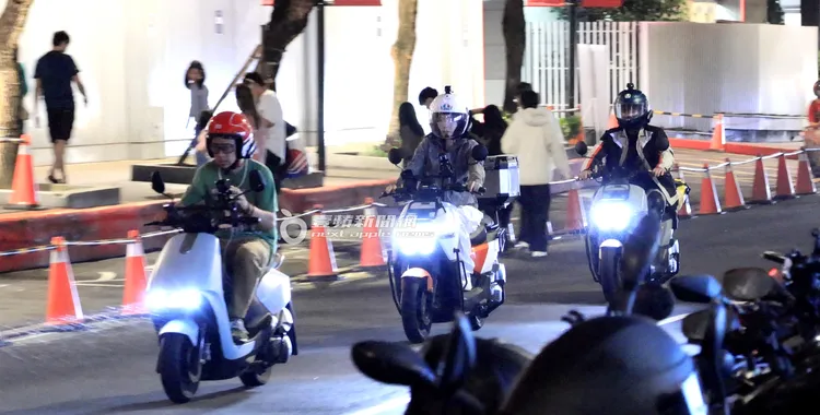 樂天應援團團長山G哥（左），帶頭邊騎車邊滑手機。特勤中心攝