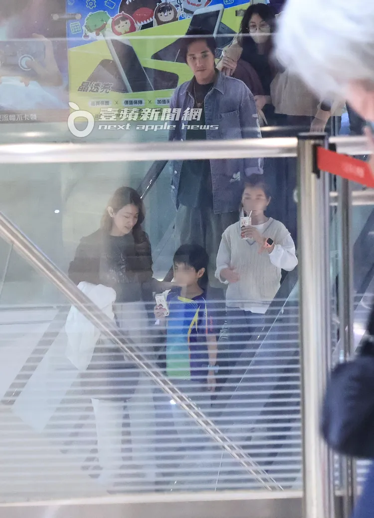 藍正龍（上）帶著前妻及小孩們搭乘手扶梯下樓。特勤中心攝