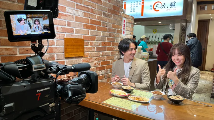 愛紗（右）跟高志出外景，大啖台灣美食。國興衛視提供