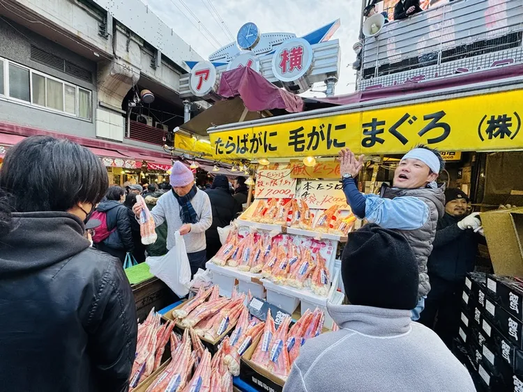 東京上野阿美橫近日湧入大批前來購買鱈場蟹（帝王蟹）、生鮪魚塊等年菜食材的民眾，生意強強滾。 中央社