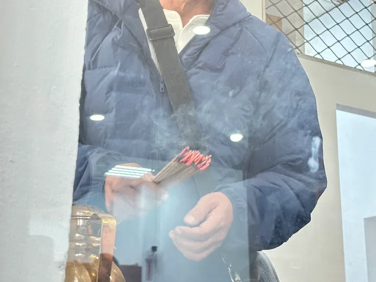 王父點香燃起對妻女的思念。曾佳俊攝