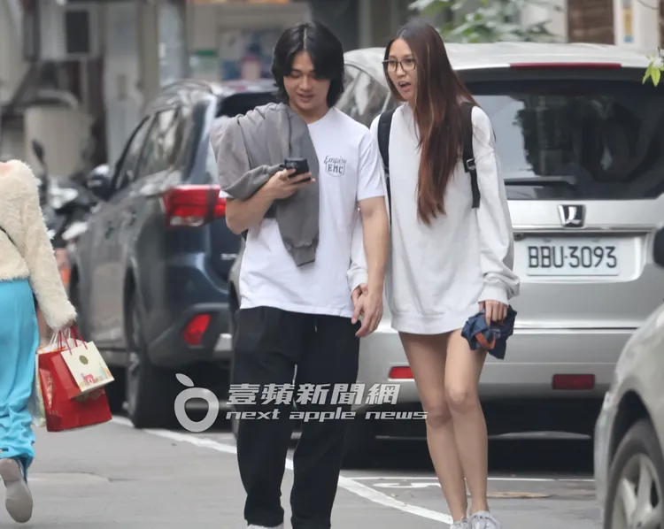 Dora（右）跟長髮男散步時從勾手臂到牽小手，男方手臂看起來也很粗壯。特勤中心攝