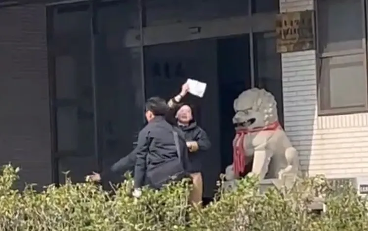 民進黨立委林岱樺疑涉助理費案，被帶回調查南部機動組應訊時，突手拿白紙對著媒體大喊「政治干預司法、司法干預初選」。讀者提供