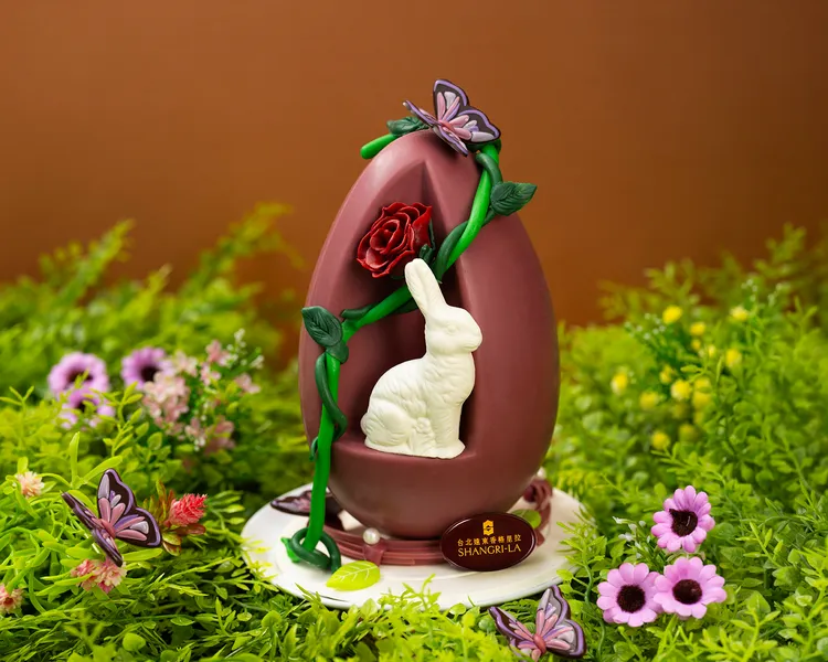 玫瑰綻放童話風采，「奇幻玫瑰彩蛋」選用紅寶石巧克力精雕玫瑰與藤蔓，搭配翩翩飛舞的巧克力蝴蝶，內藏純白巧克力兔，微酸莓果與濃郁奶香交織，每個1580元。台北遠東香格里拉提供