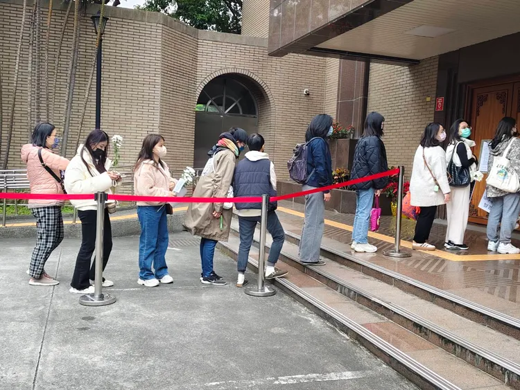 民眾帶著白菊花到場要旁聽開庭情形。張欽攝