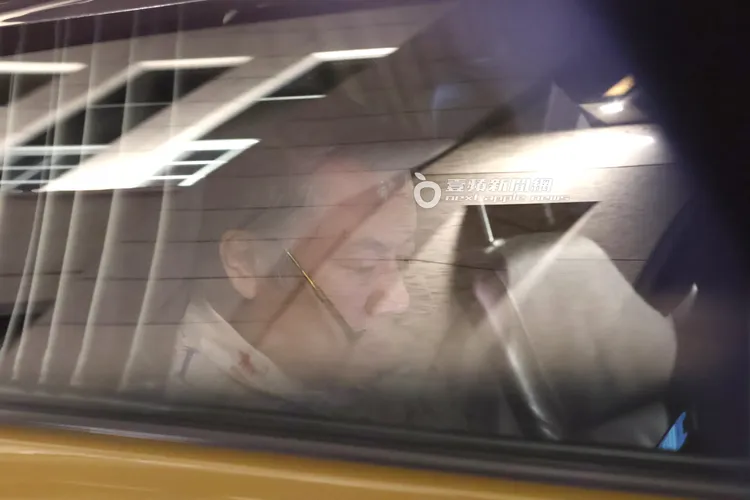 蔡康永在計程車裡脫下帽子，眼鏡放到人中滑手機。特勤中心攝