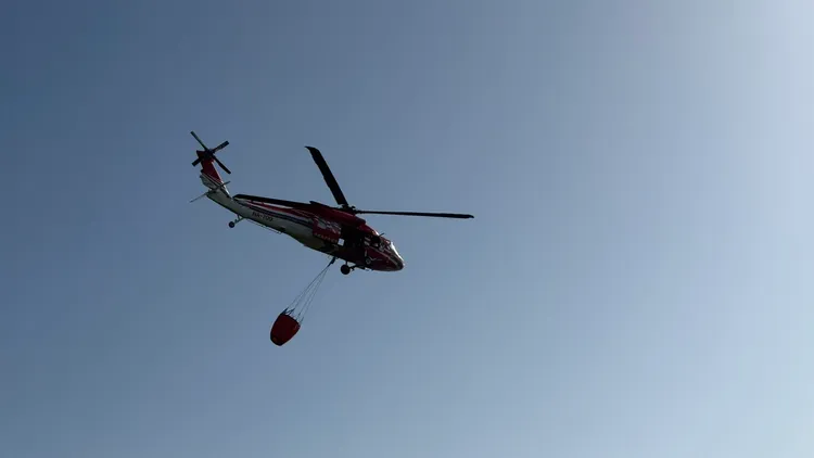 空勤總隊派出黑鷹直升機NA-709執行三架次向陽明山起火點投水。台北市政府消防局提供