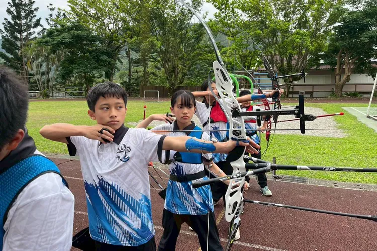 一整排拉滿弓的小小射手，瞄準的不只是靶心，更是夢想。基金會的支持，讓孩子們在文化與競技之路上勇敢站穩腳步。林思宏X5醫師慈善基金會提供