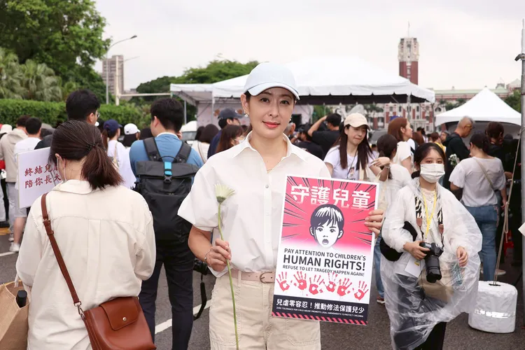賈永婕手舉「守護兒童」標語。彭欣偉攝