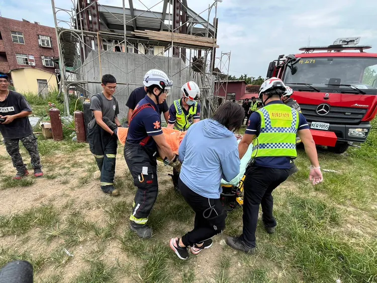 消防局救護人員將林姓工人抬上救護車送醫。民眾提供