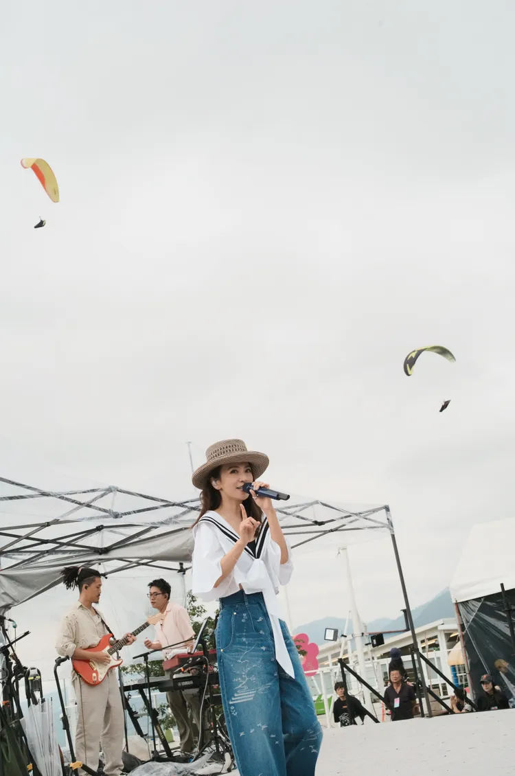 田馥甄開唱，飛行傘盤旋空中，彷彿彎彎微笑。何樂音樂提供