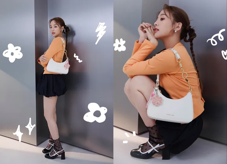 吳映潔換上橘色貼身上衣搭配黑色氣球短裙，造型活潑俏麗。品牌提供