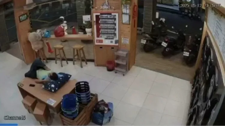 男子自備枕頭，就在自助洗衣店大桌上睡覺。翻攝畫面