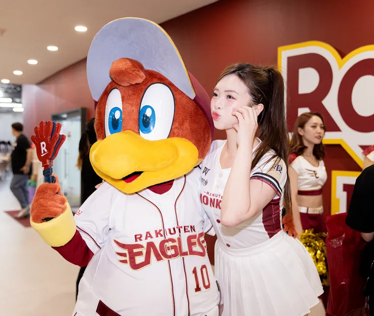 曲曲（右）和東北樂天金鷺吉祥物合影。樂天桃猿提供