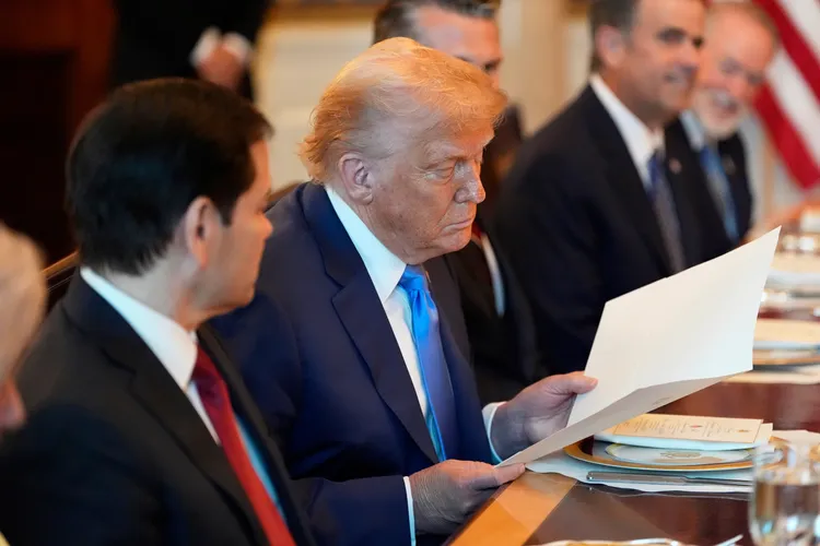 川普細細端詳信件，露出滿意表情。美聯社