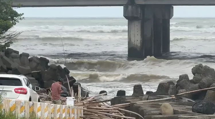 有人沒注意到有海嘯警報，還在河邊釣魚。民眾提供