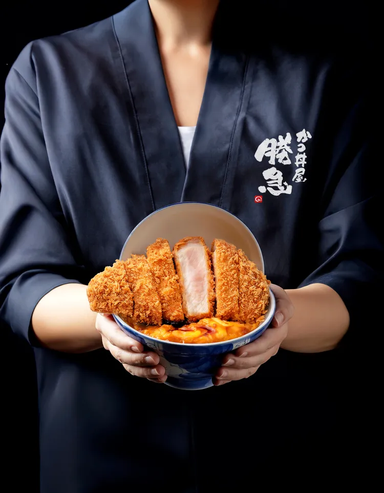 擺盤採用日本精緻彩釉蓋碗，碗蓋立起時呈現如舞台劇般3D空間，超出碗口的厚切豬排，歐姆蛋與豬排分離製作的層層堆疊，帶來視覺與味道撞擊的新食感丼飯體驗。業者提供