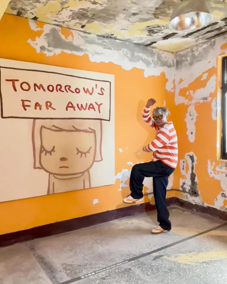 奈良美智穿著Peter Wu工裝牛仔褲，在自己的藝術作品前擺出俏皮姿勢。翻攝奈良美智Threads