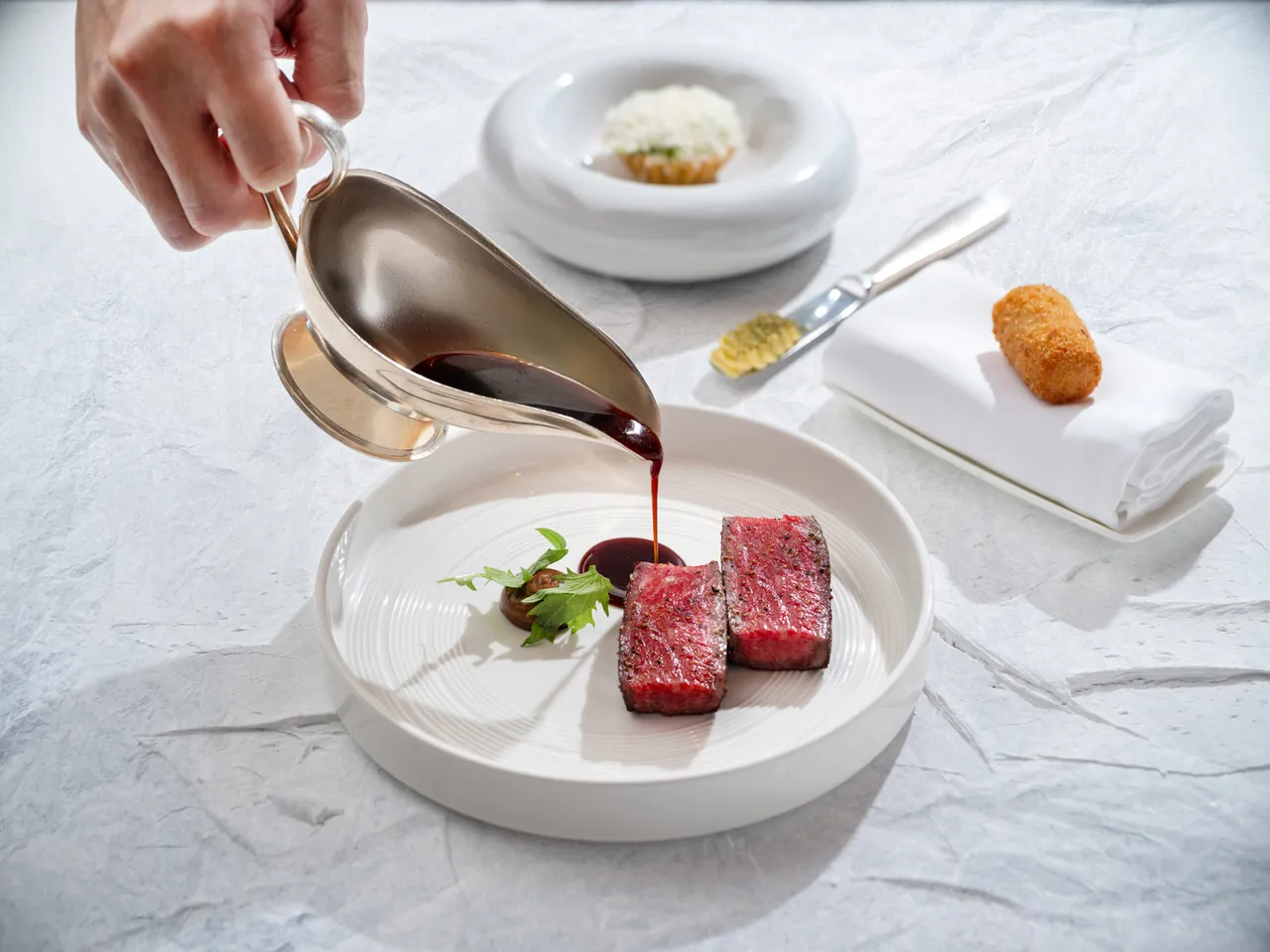 「Bencotto」夏季套餐「炙烤 F1 和牛纽约客、黑蒜、红酒酱汁、凯萨沙拉、马铃薯」,主厨并特别发挥巧思将共享佳肴的丰盛细腻化作独享精致美馔。台北文华东方酒店提供
