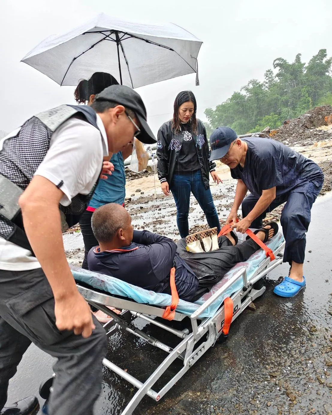玛夏卫生所医护与EMT人员徒步穿越民生大桥,以担架和人力接力的方式,护送病患下山送医。取自高荣脸书
