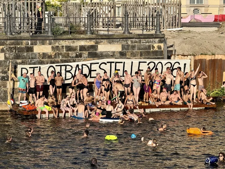 柏林市中心史普里河舉行游泳抗議活動，抗爭者聚集在臨時搭建的親水平台上，身後懸掛「2026年試辦河泳區！」布條，呼籲市府解除市中心百年禁泳令。 中央社