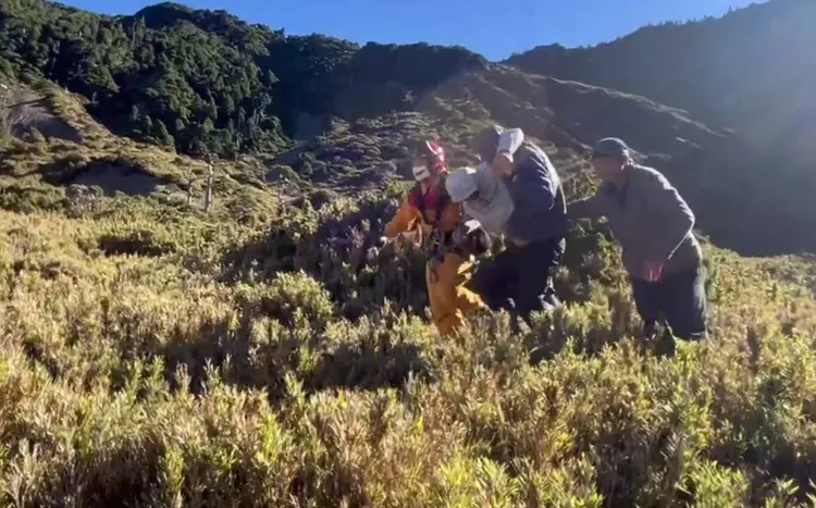 直升機停在南湖山屋附近，由救援人員將許姓登山客帶上直升機。空勤總隊