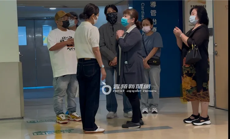 蕭敬騰（中）聚精會神聽著護理人員告知事項，蕭敬騰媽媽（右）也在旁聆聽。特勤中心攝