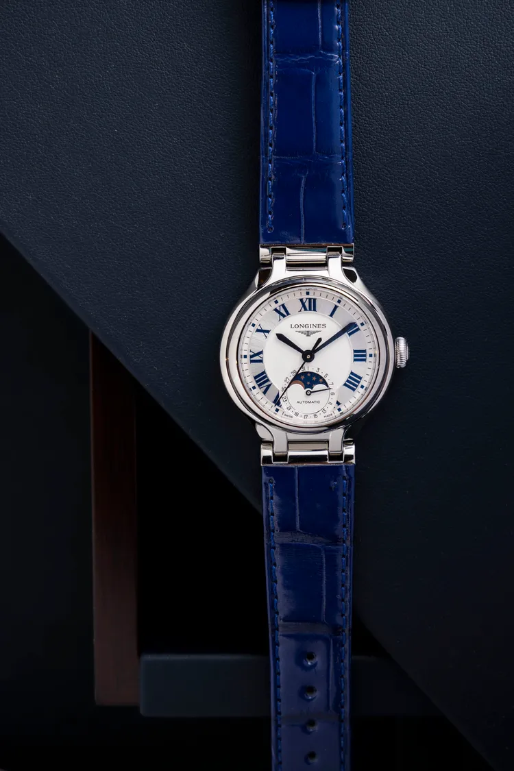 浪琴PRIMALUNA新月系列雙色面盤腕錶，34mm，不鏽鋼錶殼，銀色太陽放射紋漆繪藍色羅馬數字時標，搭配半啞光白色面盤，藍色鱷魚皮革錶帶，浪琴表獨家L899.5自動上鍊機械機芯，動力儲存72小時，防水深度30米，8萬7800元。品牌提供