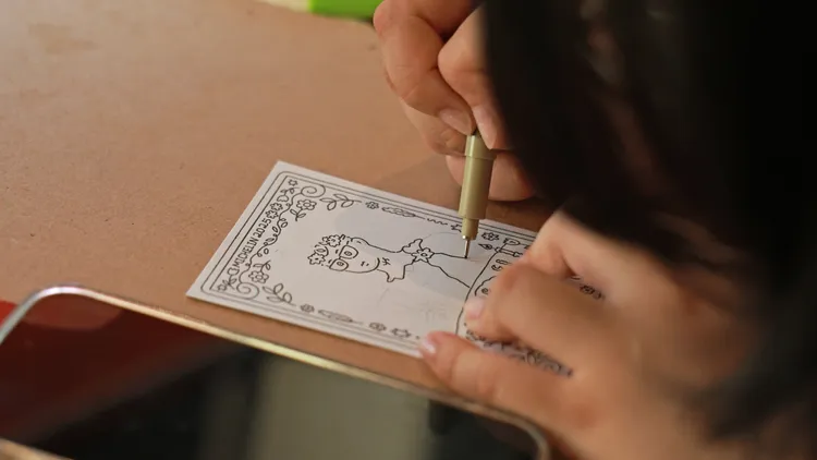 似顏繪藝術家Sarah替賓客繪製個人畫像小卡。業者提供