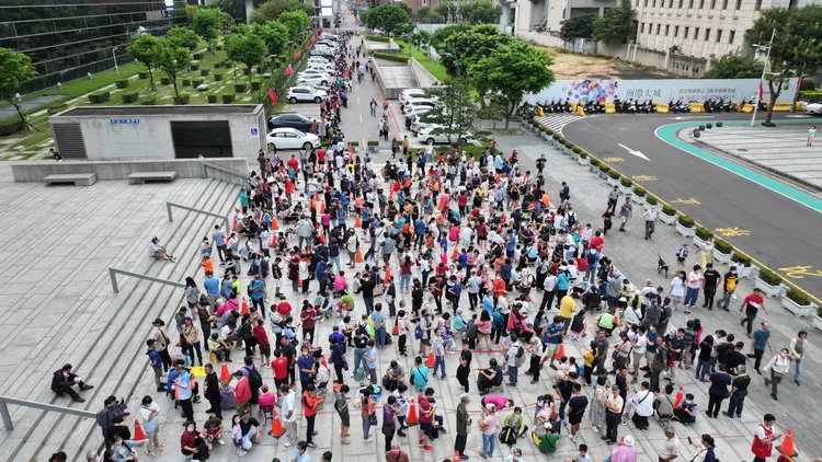 參加國慶升旗典禮，府會園道旁排隊人龍。市府提供