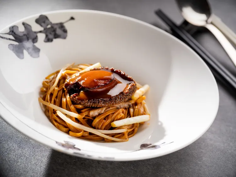 「雅閣」推出秋蟹尊饌饗宴「南非鮑魚燴伊麵」，鮑魚Q彈飽滿、鮮香四溢，恣享深邃豐盈的交融美味。台北文華東方酒店提供