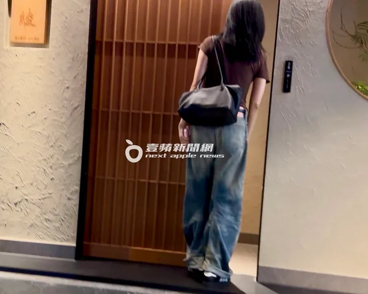 楊謹華揹著大包包準備走進米其林一星級日本料理店。特勤中心攝