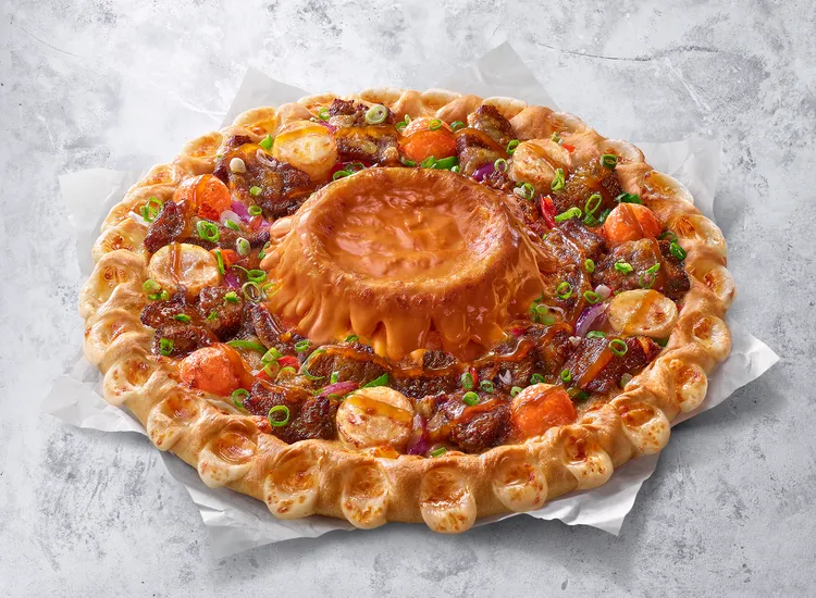 「煙燻起司火山熔岩餅皮」推薦可搭配屋馬聯名款「月見七盎司厚燒牛披薩」一起品嚐。必勝客提供