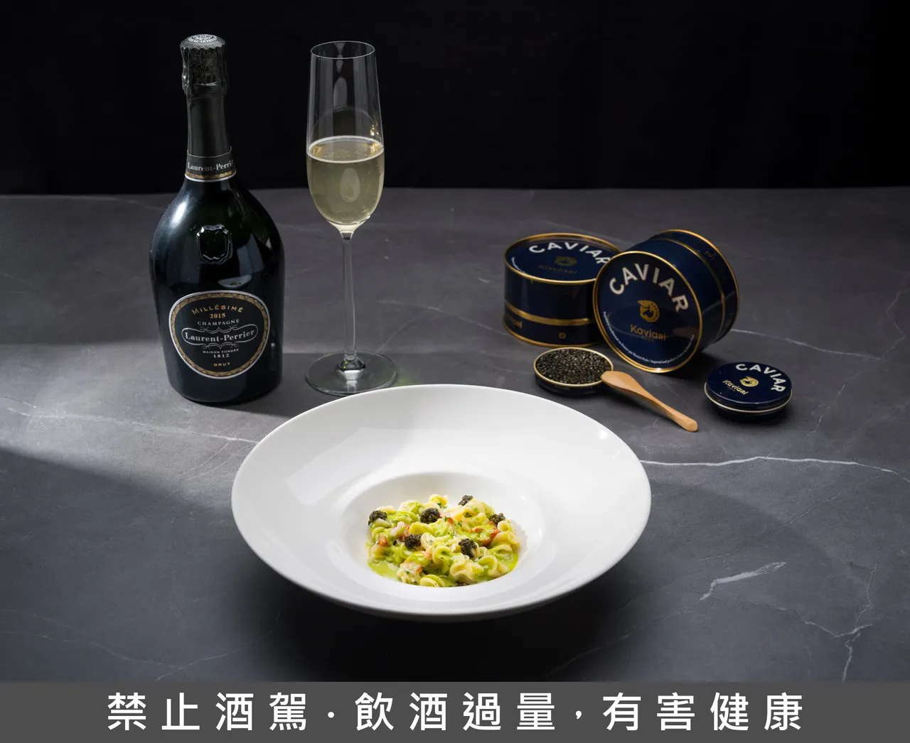 「手工螺旋麵、帝王蟹、煙燻奶油、香草醬汁」搭配「薩魯加」(Sevruga) 魚子醬，佐以「羅蘭年份香檳2015 Laurent-Perrier Brut Millésimé, Champagne, France 2015」。台北文華東方酒店提供