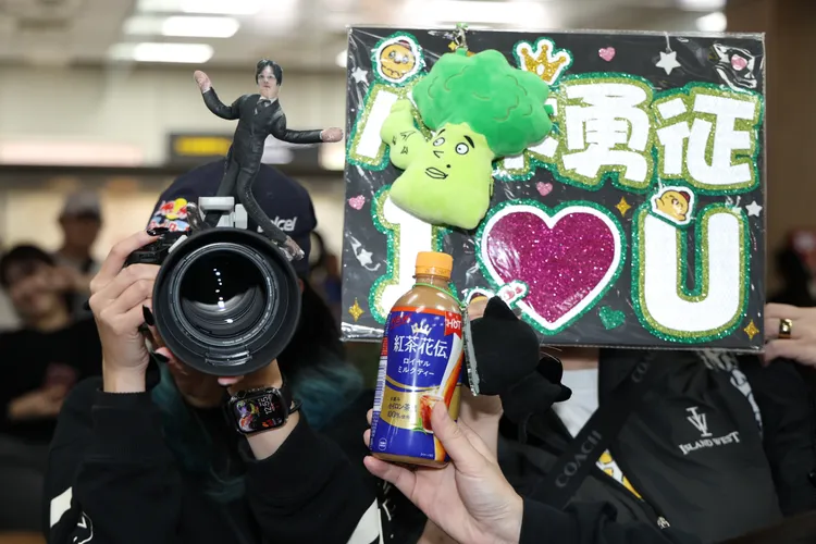 有粉絲在鏡頭上放八木勇征的立牌及「筋肉花椰菜」玩偶接機。彭欣偉攝