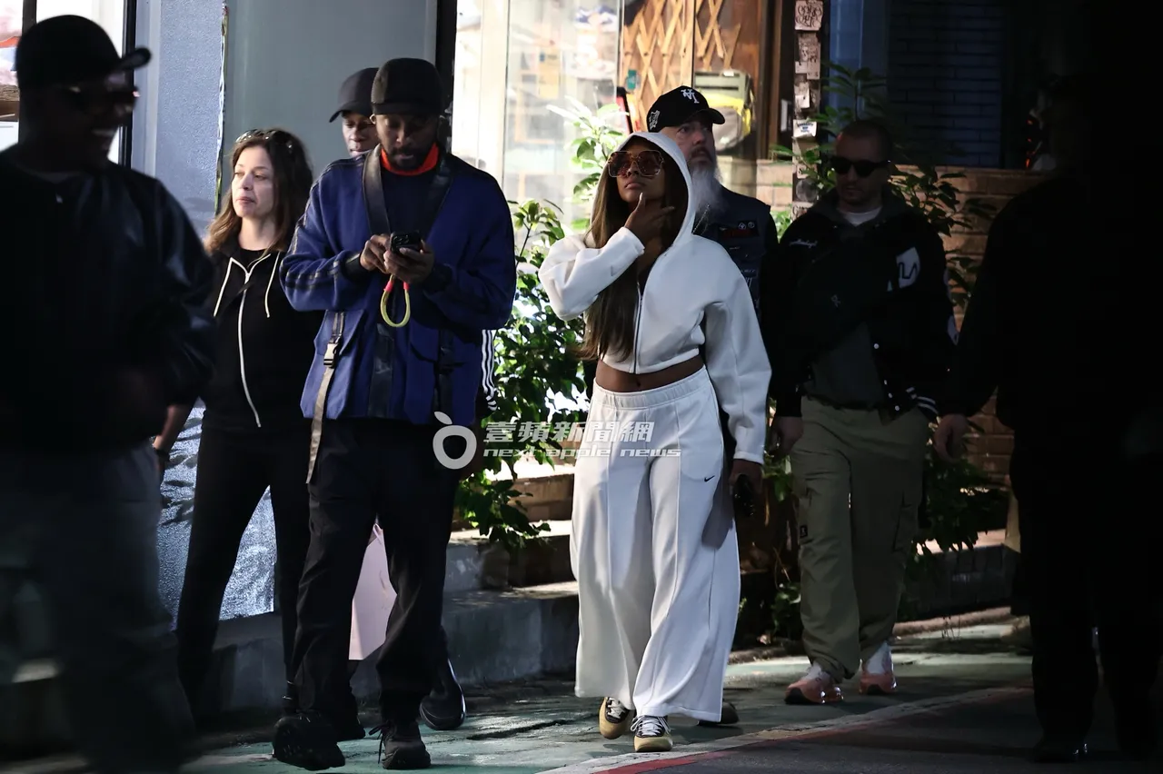 一行人逛不停，will.i.am（左三）邊走路邊拿手機。特勤中心攝