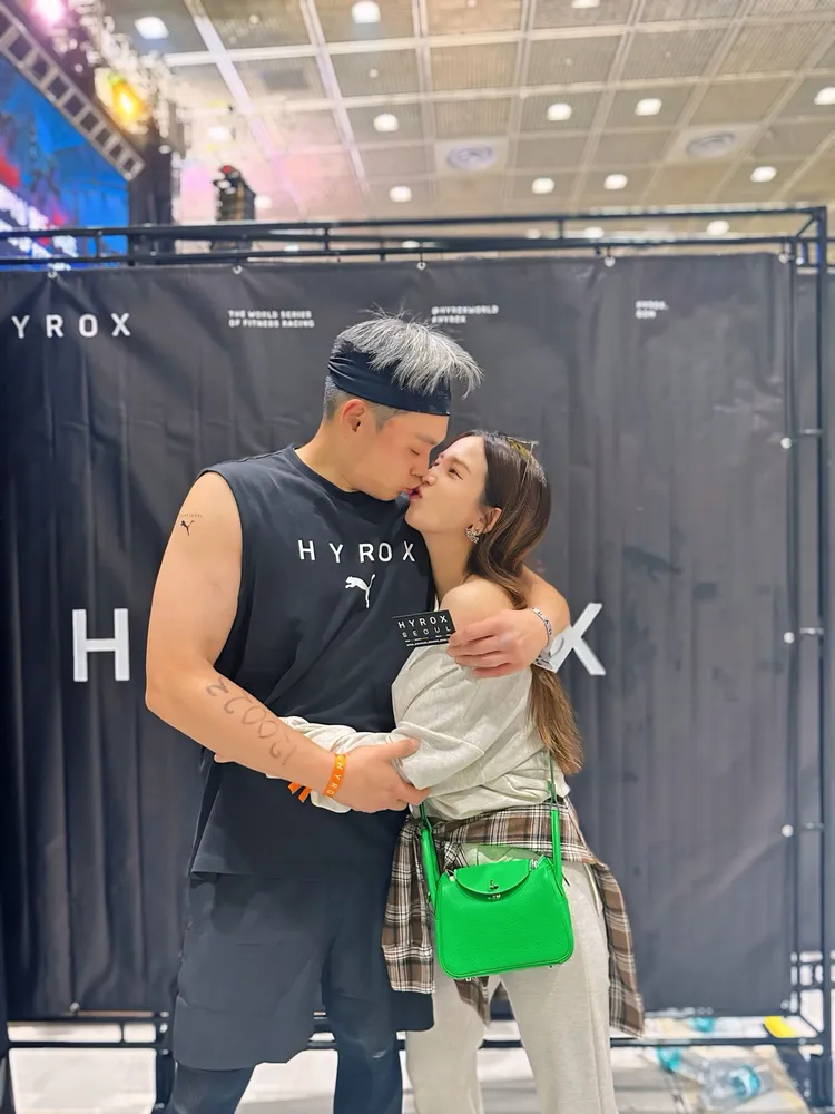 愛雅（右）老公萬先生參加首爾「HYROX健身賽事」，她場邊熱情加油，大方放閃獻吻。愛雅辣呦提供
