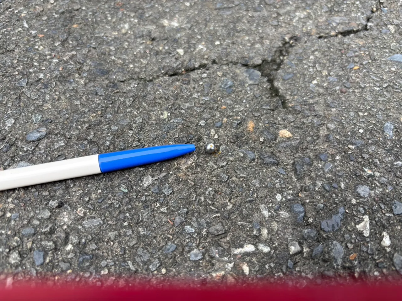 警方在地上发现一颗钢珠。翻摄画面