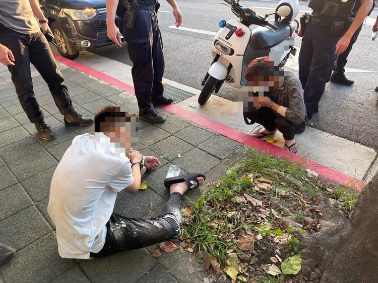 兩名嫌犯拒檢衝撞警方後棄車逃逸，一度要闖入鏡電視大樓藏匿，遭大批警員圍捕壓制。翻攝畫面